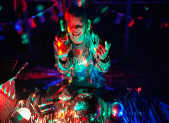 boy in a dark room with glowing neon spot lights all over