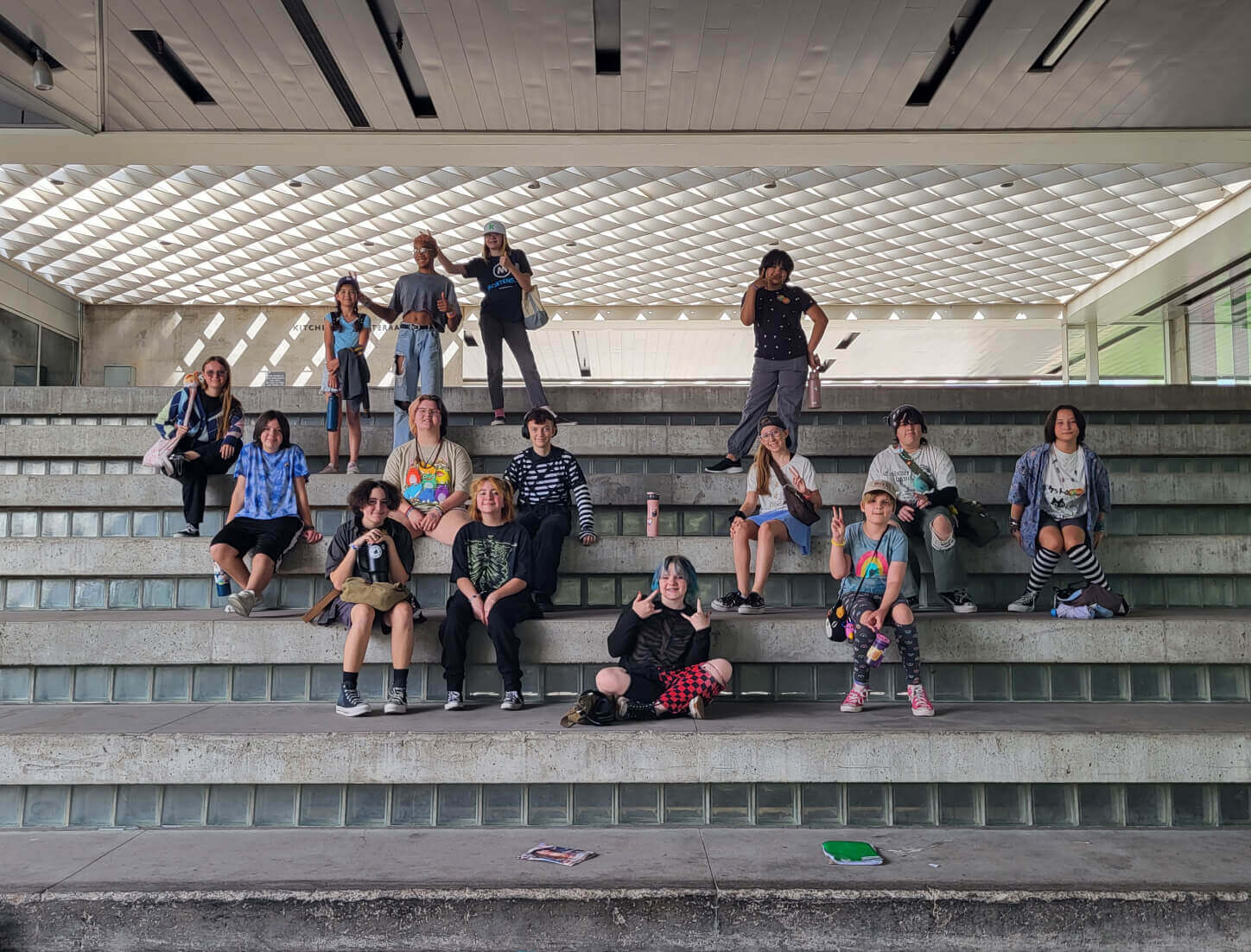 Group of people seated on wide concrete steps