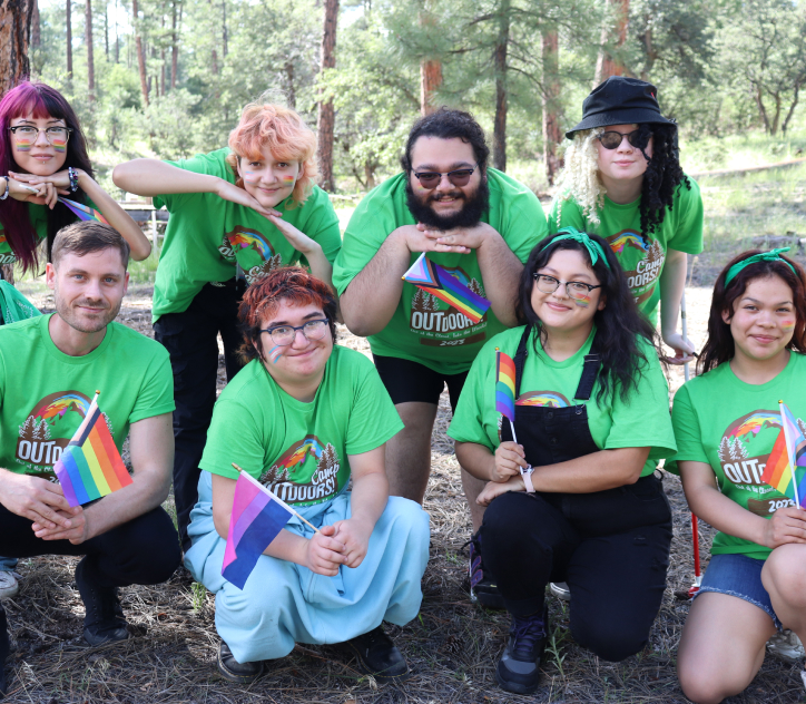 Group of campers posing in front of a tree