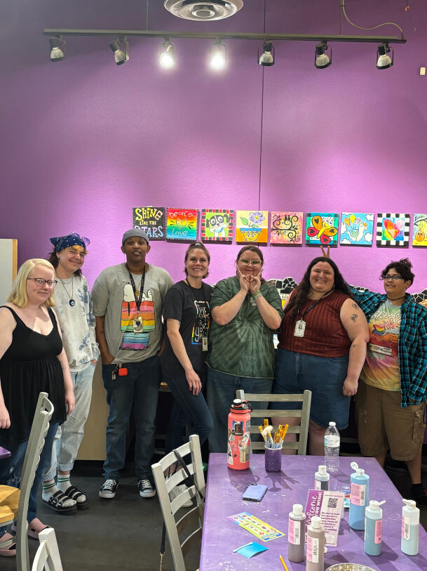 Group of LGBTQ young adults at a painting party