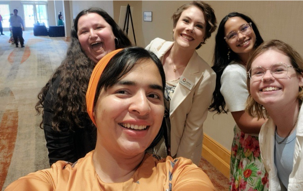 Group of LGBTQ people taking a selfie at a conference