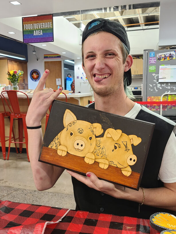 Male teen thrilled about his wood burned pig plaque