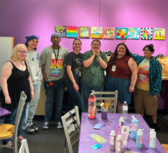 Group of LGBTQ young adults at a painting party