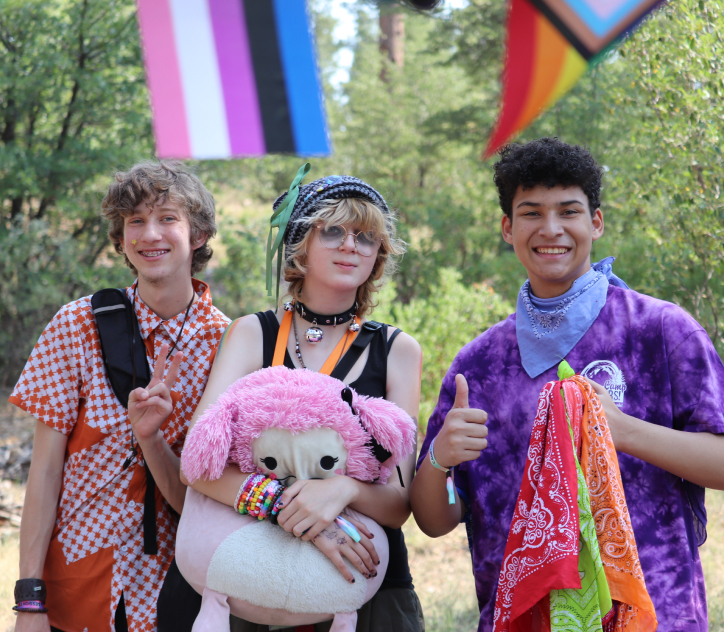 Three youth members posing at Camp Outdoors