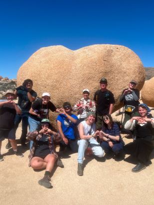 Group of LGBTQ youth posing in front of the rocks at Papago Park