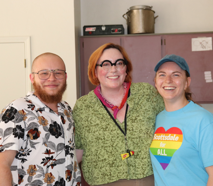 Three staff members standing together and smiling