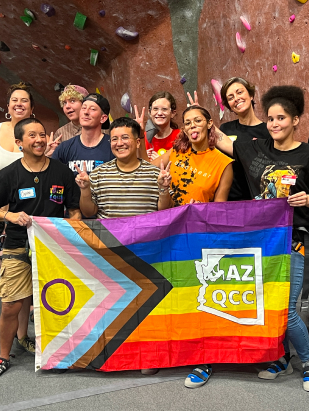 Group of happy youth making funny faces and holding the rainbow AZ QCC flag