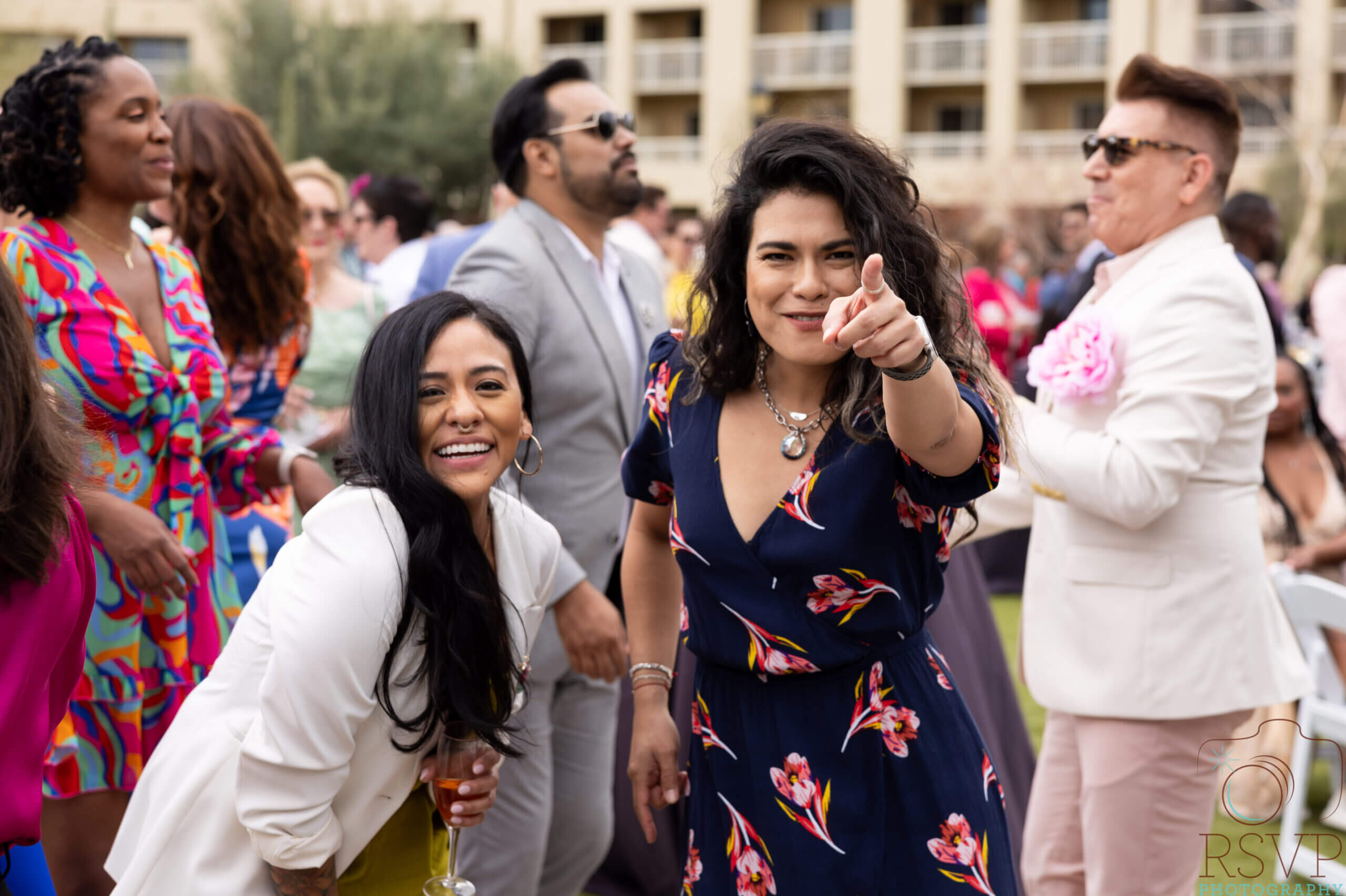 People enjoying an outdoor party, smiling happily.