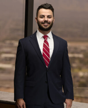 Smiling professional in navy suit and red tie